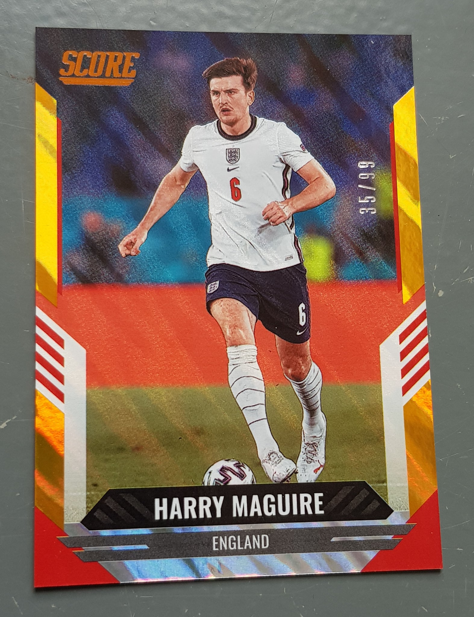 2021-22 Panini Score FIFA Harry Maguire #73 Orange Lava Parallel /99 Trading Card