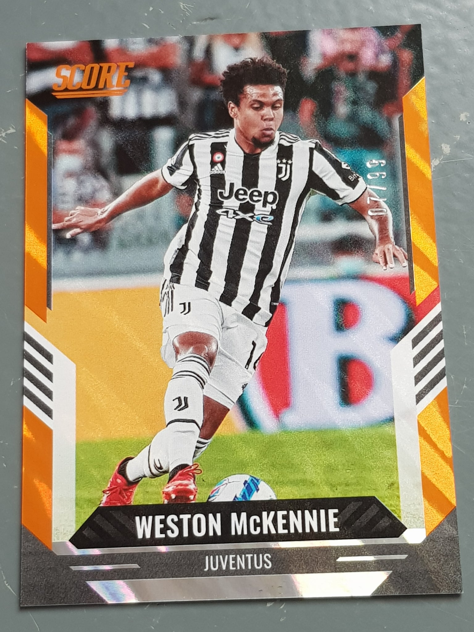 2021-22 Panini Score FIFA Weston McKennie #135 Orange Lava Parallel /99 Trading Card